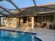 Screened pool with patio and seating area, perfect for outdoor relaxation and entertainment at 9923 Se 64Th Ave, Belleview, FL 34420