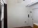 Bright room with fresh white walls and wood flooring, with a door on the right at 9923 Se 64Th Ave, Belleview, FL 34420