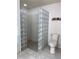 Bathroom features walk-in shower with glass block partition wall at 9923 Se 64Th Ave, Belleview, FL 34420