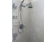 Shower features modern shower head with tiled walls and built-in caddy shelves at 9923 Se 64Th Ave, Belleview, FL 34420