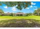View of the back of the home from expansive and well-maintained backyard at 9925 Sw 95Th Loop, Ocala, FL 34481