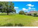 Expansive backyard featuring mature trees and well-manicured lawn and home at 9925 Sw 95Th Loop, Ocala, FL 34481
