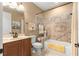 Functional bathroom features a tiled shower-tub combination, toilet, and vanity with storage at 9925 Sw 95Th Loop, Ocala, FL 34481