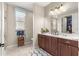 Bright bathroom featuring double vanity, neutral paint, and decorative towels at 9925 Sw 95Th Loop, Ocala, FL 34481