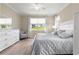 Bright bedroom with hardwood floors, large window, and white dresser at 9925 Sw 95Th Loop, Ocala, FL 34481