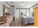 Comfortable bedroom with a large bed, wooden floors, and a view of the outdoors at 9925 Sw 95Th Loop, Ocala, FL 34481