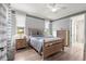 Well-lit bedroom featuring a large bed, wooden furniture, and a view from the window at 9925 Sw 95Th Loop, Ocala, FL 34481