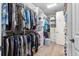 Walk-in closet with custom shelving and clothing racks at 9925 Sw 95Th Loop, Ocala, FL 34481