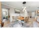 Bright dining room featuring a modern light fixture, decor, and neutral paint colors with light tile flooring at 9925 Sw 95Th Loop, Ocala, FL 34481