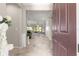 Open foyer view into the dining area and kitchen showcasing the home's spacious layout at 9925 Sw 95Th Loop, Ocala, FL 34481