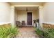 Inviting front porch with seating, decorative accents, and a brick paver floor at 9925 Sw 95Th Loop, Ocala, FL 34481