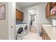 Laundry room with washer, dryer, sink, and access to the walk-in closet at 9925 Sw 95Th Loop, Ocala, FL 34481