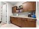 Functional laundry room featuring cabinetry and sink with walk-in closet access at 9925 Sw 95Th Loop, Ocala, FL 34481