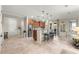 Open-concept living space with tile flooring, stainless steel appliances, and a breakfast bar at 9925 Sw 95Th Loop, Ocala, FL 34481