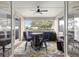 Relaxing covered patio featuring a ceiling fan, stylish outdoor furniture, and views of the landscaped backyard at 9925 Sw 95Th Loop, Ocala, FL 34481