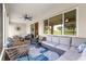 Spacious screened porch with comfortable seating; views of the well-manicured lawn at 9925 Sw 95Th Loop, Ocala, FL 34481