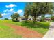 Expansive lawn with a mulch path and lush greenery surrounding the property at 9925 Sw 95Th Loop, Ocala, FL 34481