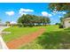 Lush green lawn with decorative mulch path and mature trees in a tranquil setting at 9925 Sw 95Th Loop, Ocala, FL 34481