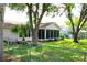 Spacious backyard featuring a screened-in porch and mature trees and landscaping at 8896 Sw 116Th Place Rd, Ocala, FL 34481
