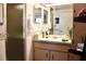 Bathroom with a shower, large mirror, vanity with cabinet, and pink accents at 8896 Sw 116Th Place Rd, Ocala, FL 34481