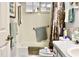 Compact bathroom features a combination tub and shower, neutral tiles, and practical fixtures at 8896 Sw 116Th Place Rd, Ocala, FL 34481