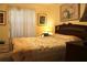 Cozy main bedroom with a decorative comforter, bedside tables, and serene artwork at 8896 Sw 116Th Place Rd, Ocala, FL 34481