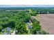 Aerial view of a home surrounded by lush greenery and fields, with a driveway at 1133 Nw 122Nd Pl, Citra, FL 32113