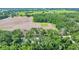 Aerial view showcasing lush greenery, trees, and fields surrounding a charming home at 1133 Nw 122Nd Pl, Citra, FL 32113