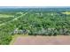 Expansive aerial view of a property featuring a large field and lush green trees at 1133 Nw 122Nd Pl, Citra, FL 32113