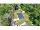 Aerial view of the home, property, driveway, and surrounding trees at 1133 Nw 122Nd Pl, Citra, FL 32113