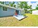Backyard deck featuring outdoor furniture, potted plants and sliding glass door at 1133 Nw 122Nd Pl, Citra, FL 32113
