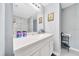 Bright bathroom featuring a white vanity with a quartz countertop, updated fixtures, and a walk-in shower at 1133 Nw 122Nd Pl, Citra, FL 32113