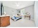 Light-filled bedroom with tile flooring, ceiling fan, and neutral paint with space for a queen bed at 1133 Nw 122Nd Pl, Citra, FL 32113