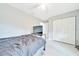 Bedroom features light-colored walls, ceiling fan, closet, and light tile flooring at 1133 Nw 122Nd Pl, Citra, FL 32113