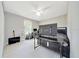 Simple bedroom with grey walls, light ceiling fan, and light tile flooring at 1133 Nw 122Nd Pl, Citra, FL 32113