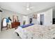 Bedroom features neutral walls, tile flooring, ceiling fan and is adjacent to a bathroom and walk-in closet at 1133 Nw 122Nd Pl, Citra, FL 32113
