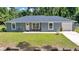 Charming single-story home with well-maintained lawn and inviting front entrance at 1133 Nw 122Nd Pl, Citra, FL 32113
