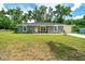 Well-kept single-story home with lush front yard and attached garage at 1133 Nw 122Nd Pl, Citra, FL 32113