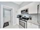 Updated kitchen with stainless steel appliances, granite countertops, and modern white cabinets at 1133 Nw 122Nd Pl, Citra, FL 32113