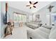 Spacious living room featuring high ceilings, bright windows, and tiled floors at 1133 Nw 122Nd Pl, Citra, FL 32113