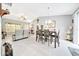 Bright living room features vaulted ceilings, tile floors, and dining area with modern chandelier at 1133 Nw 122Nd Pl, Citra, FL 32113