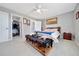 Spacious main bedroom featuring light-colored flooring, a ceiling fan, and a walk-in closet at 1133 Nw 122Nd Pl, Citra, FL 32113