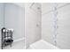Walk-in shower with gray tiling and modern fixtures showcasing a clean and updated space at 1133 Nw 122Nd Pl, Citra, FL 32113
