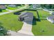 Aerial shot of a well-manicured home with a lush green lawn and a long driveway at 11330 Sw 61St Cir, Ocala, FL 34476