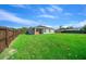Spacious backyard featuring a well-maintained lawn and a wooden fence, perfect for outdoor activities at 11330 Sw 61St Cir, Ocala, FL 34476
