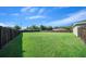 Large, grassy backyard with a dark wooden fence, offering plenty of room for landscaping and outdoor enjoyment at 11330 Sw 61St Cir, Ocala, FL 34476