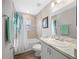 Cozy bathroom showcasing a tub with shower, single sink vanity, and wood-look flooring at 11330 Sw 61St Cir, Ocala, FL 34476