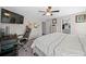 Spacious primary bedroom with a ceiling fan, work space, and neutral decor, offering a serene retreat at 11330 Sw 61St Cir, Ocala, FL 34476