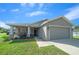 Charming single-story home featuring a two-car garage, landscaped front yard, and covered front porch at 11330 Sw 61St Cir, Ocala, FL 34476