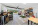 View of an organized two car garage with storage shelving and an open garage door to the home's front yard at 11330 Sw 61St Cir, Ocala, FL 34476